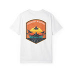 White t-shirt with graphic of fighter jets and sunset text Covered By His Wings on back